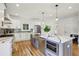 Spacious kitchen with a farmhouse sink, stainless steel appliances, and white cabinets at 1732 Beecher Nw St, Atlanta, GA 30310