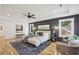 Spacious main bedroom with dark-colored accent wall and hardwood floors at 1732 Beecher Nw St, Atlanta, GA 30310