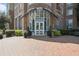 Elegant building entrance with brick facade and landscaping at 325 E Paces Ferry Ne Rd # 2104, Atlanta, GA 30305