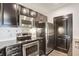 Modern kitchen with dark cabinetry and stainless steel appliances at 325 E Paces Ferry Ne Rd # 2104, Atlanta, GA 30305