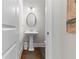 Elegant powder room with pedestal sink and hardwood floors at 332 Symphony Se Way, Smyrna, GA 30080