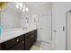 Modern bathroom with dark vanity, double sinks, and a large mirror at 332 Symphony Se Way, Smyrna, GA 30080