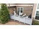 Private patio with seating area and grill, surrounded by a fence at 332 Symphony Se Way, Smyrna, GA 30080