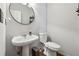 Stylish powder room with pedestal sink and modern toilet at 5785 Stephens Mill Dr, Sugar Hill, GA 30518