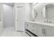 Modern bathroom with double vanity and marble-tiled floors at 5785 Stephens Mill Dr, Sugar Hill, GA 30518