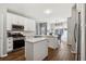 Modern kitchen with white cabinets, island, and stainless steel appliances at 5785 Stephens Mill Dr, Sugar Hill, GA 30518