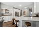 Modern kitchen with white cabinets, quartz countertops, and breakfast bar at 5785 Stephens Mill Dr, Sugar Hill, GA 30518