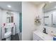 Basement bathroom with toilet, sink, and stylish mirror at 1765 Rubye Lee Ln, Dacula, GA 30019