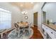 Charming dining room with hardwood floors and white table at 1765 Rubye Lee Ln, Dacula, GA 30019