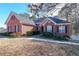 Red brick house with a walkway and landscaping at 1765 Rubye Lee Ln, Dacula, GA 30019