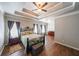 Main bedroom with tray ceiling, wood floors, and large windows at 1765 Rubye Lee Ln, Dacula, GA 30019