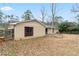 View of backyard featuring lawn, mature trees, siding on house, fence, and a bright, sunny sky at 1850 Cashmere Ct, Lithonia, GA 30058