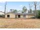 View of the backyard featuring a patio area, siding on house, lawn, mature trees, and a sunny sky at 1850 Cashmere Ct, Lithonia, GA 30058