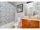 Traditional bathroom featuring a tub with shower curtain, wood vanity, and mirrored medicine cabinet at 1850 Cashmere Ct, Lithonia, GA 30058