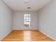 Minimalist bedroom with hardwood floors, a large window and neutral gray wall paint at 1850 Cashmere Ct, Lithonia, GA 30058