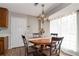 Cozy dining area with round table, chandelier, and large window providing natural light at 1850 Cashmere Ct, Lithonia, GA 30058