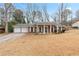 Charming single-story brick home featuring a welcoming front porch and a two-car garage at 1850 Cashmere Ct, Lithonia, GA 30058