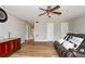 Spacious living room featuring hardwood floors, ceiling fan, and comfortable leather seating at 1850 Cashmere Ct, Lithonia, GA 30058