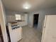 Kitchen with white cabinets, tile floors, and gas range at 2244 Alpha Dr, Decatur, GA 30032