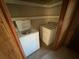 Laundry closet with washer, dryer, and shelving at 2244 Alpha Dr, Decatur, GA 30032