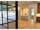 Stylish bar area with cabinetry, sink, and views of the pool through the floor-to-ceiling black framed sliding doors at 2515 Habersham Nw Rd, Atlanta, GA 30305