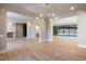 Open concept dining room with hardwood floors, modern chandelier, and fireplace at 2515 Habersham Nw Rd, Atlanta, GA 30305