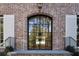 Elegant arched front door with black metal frame and glass panels at 2515 Habersham Nw Rd, Atlanta, GA 30305