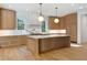 Modern kitchen with light oak cabinetry, marble countertops, and hardwood floors at 2515 Habersham Nw Rd, Atlanta, GA 30305