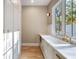 Bright laundry room with white cabinetry and a farmhouse sink at 2515 Habersham Nw Rd, Atlanta, GA 30305