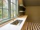 Bright laundry room with window, open shelving, and patterned tile flooring at 2515 Habersham Nw Rd, Atlanta, GA 30305