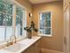 Well-lit mudroom featuring a marble countertop, brass fixtures, and ample natural light at 2515 Habersham Nw Rd, Atlanta, GA 30305