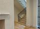 Modern staircase with sleek black railing complements the neutral walls and hardwood floors at 2515 Habersham Nw Rd, Atlanta, GA 30305