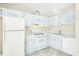 Bright kitchen with white cabinets, gas range, and refrigerator at 4018 Bayside Cir, Atlanta, GA 30340