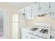 Kitchen boasts white appliances and cabinets at 4018 Bayside Cir, Atlanta, GA 30340