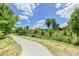 A paved pathway winds through a lush green landscape at 864 Melrose Sw Dr, Atlanta, GA 30310