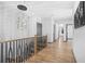 Upstairs hallway with hardwood floors, modern light fixture, and gray walls at 3378 Bachelor St, Atlanta, GA 30344