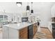 Modern kitchen island with a waterfall quartz countertop and black appliances at 3378 Bachelor St, Atlanta, GA 30344