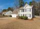 Two-story house with beige siding, a two-car garage, and a neatly landscaped yard at 3408 Sandlake Dr, Marietta, GA 30008