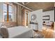 Bedroom features exposed brick, large windows, and a view of the city at 3235 Roswell Ne Rd # 615, Atlanta, GA 30305
