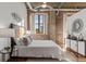 Bright bedroom featuring exposed brick, modern fixtures, and an open layout at 3235 Roswell Ne Rd # 615, Atlanta, GA 30305