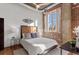 Sunlit bedroom features exposed brick walls, large windows, and modern decor at 3235 Roswell Ne Rd # 615, Atlanta, GA 30305