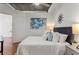 Bedroom boasts exposed ceiling details, hardwood floors, art, and bedside lamps at 3235 Roswell Ne Rd # 615, Atlanta, GA 30305
