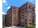 A brick apartment building featuring many windows, balconies, and street parking at 3235 Roswell Ne Rd # 615, Atlanta, GA 30305