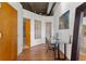 Open hallway with hardwood floors, modern art, and glass-walled accent, offering a welcoming transition between spaces at 3235 Roswell Ne Rd # 615, Atlanta, GA 30305