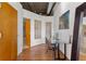 Hallway with hardwood floors, glass block, and a small desk area provides an inviting entrance into the home at 3235 Roswell Ne Rd # 615, Atlanta, GA 30305