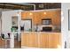 Bright kitchen with wood cabinets, modern appliances, and an adjacent dining area at 3235 Roswell Ne Rd # 615, Atlanta, GA 30305