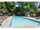 Sparkling community pool surrounded by lounge chairs, lush landscaping, and shade creates a relaxing oasis at 3235 Roswell Ne Rd # 615, Atlanta, GA 30305