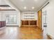 Finished basement with exposed beams, stained concrete floors, and barn door at 1078 Meadow Brook Dr, Woodstock, GA 30188