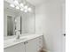 Bathroom boasts a vanity with white cabinets and a large mirror at 1078 Meadow Brook Dr, Woodstock, GA 30188