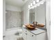 Bathroom with updated vanity, vessel sink, and tiled shower at 1078 Meadow Brook Dr, Woodstock, GA 30188